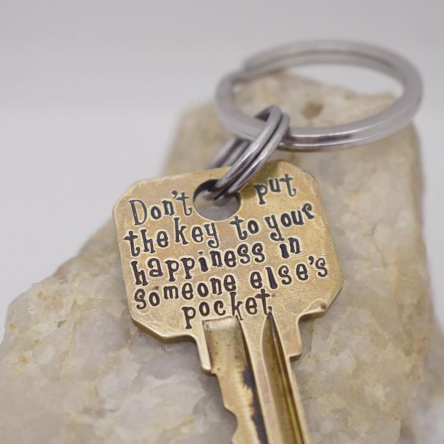 Dont put the key to your happiness in someone elses pocket brass keychain backside.jpg
